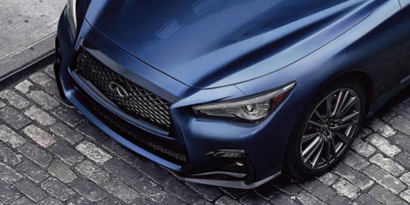 Close up of 2024 INFINITI Q50 exterior highlighting hood and front fascia