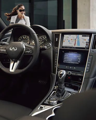 Interior view of 2024 INFINITI Q50 highlighting the driver console and gear shifter